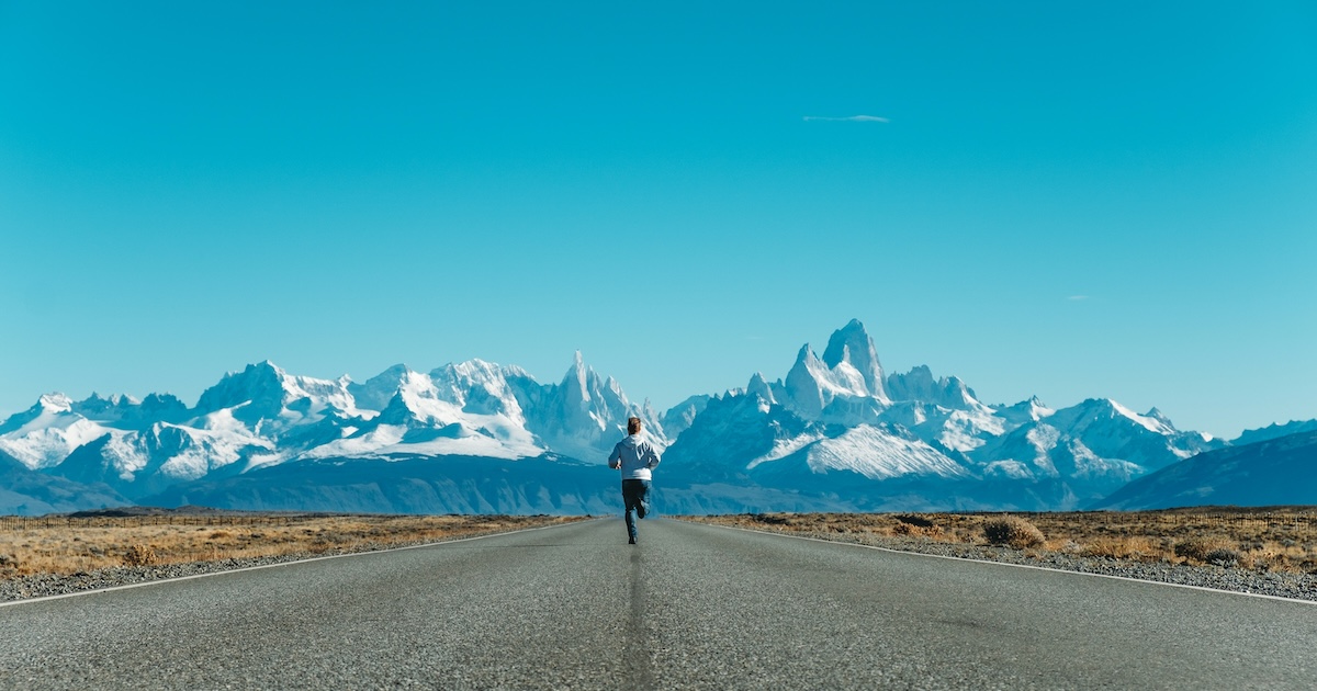 Man running towards mountains